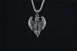 Macro detail of vintage eagle shield pendant with textured antique stainless steel finish