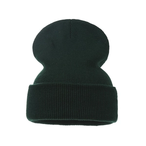 Close-up of the thick rib-knit texture and folded cuff on this dark green winter beanie