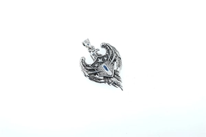 Detail view of retro eagle and shield pendant with star carvings in antique silver finish