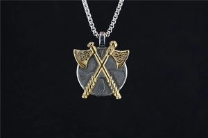 Macro detail of Viking double axe shield pendant with gold accents on steel chain