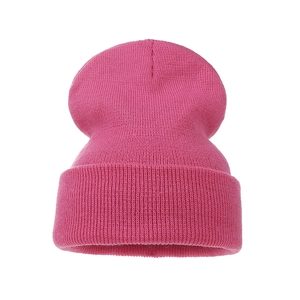 Detailed view of magenta knit beanie featuring wide cuffed brim and fine stitch texture