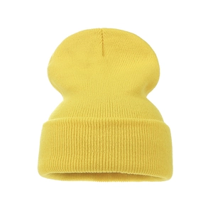Close-up detail of the bright yellow thick knit texture and folded cuff of the warm beanie