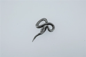 Vue macro d'une bague serpent 3D aux écailles argentées et au style punk vintage chic