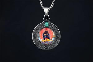 Macro shot of retro turquoise ethnic pendant with intricate religious thangka details