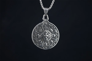 Detailed macro view of retro silver Buddhist Vajra pendant with ornate carvings