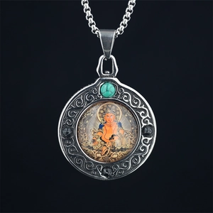 Religious Thangka pendant necklace with turquoise inlay and vintage metal scrollwork