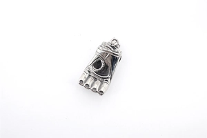 Macro view of vintage silver steel palm and eye pendant with intricate textures