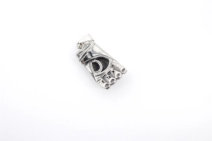 Detailed close-up of a vintage silver Spartan fist pendant with intricate textured engravings