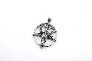Macro detail of silver Baphomet goat head pendant with oxidized vintage texture