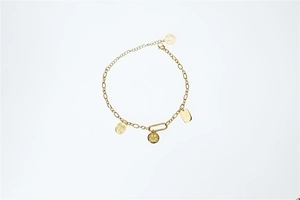 Detailed view of golden link bracelet featuring multiple smiley face charms and engraved tags