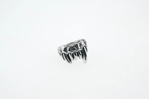 Macro shot of Viking wolf tooth ring with vintage silver finish and punk gothic details