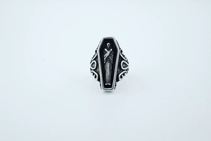 Macro detail of Gothic coffin ring featuring a robed figure and vintage silver finish