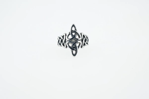 Close-up of vintage silver Celtic knot ring featuring hollow braided viking patterns