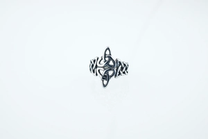Detailed view of the vintage Celtic knot ring with oxidized silver finish and triquetra patterns