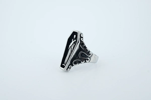 Detail of gothic coffin ring featuring inner skeleton carving and vintage punk textures
