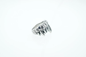 Macro shot of punk style wolf claw ring with detailed vintage black engraving textures