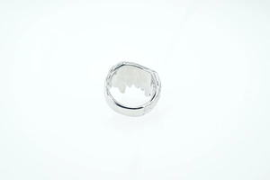 Detailed view of silver titanium steel ring with irregular lava texture and punk aesthetic