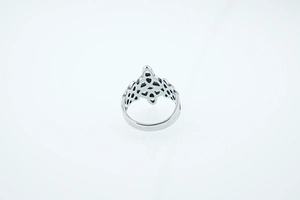 Detailed close-up of retro silver Celtic knot pattern on a stainless steel ring