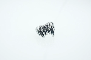 Macro shot of punk fang ring featuring vintage texture and sharp wolf tooth details