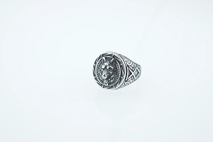 Macro shot of silver wolf head ring detailing the intricate fur texture and Nordic side patterns