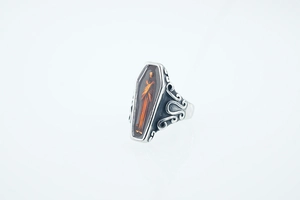 Macro shot of Gothic coffin ring with amber relief carving and scrollwork details