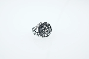 Detailed macro shot of vintage wolf head ring with Nordic Viking style engravings