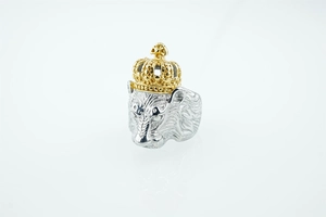 Detailed close-up of a silver lion head ring with a gold crown and fine mane textures