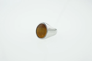 Detailed view of silver titanium steel ring with an oval brown tiger eye stone