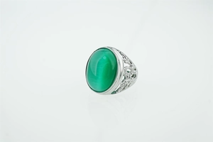 Détail macro d'une bague rétro en argent avec opale verte et gravures évidées
