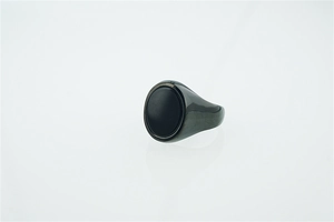 Detailed macro view of men's matte black oval signet ring in gunmetal finish