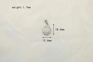 Macro view of opal halo pendant showing dimensions 18.6mm x 12.6mm on white background