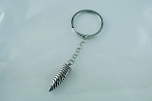 Macro detail of the bullet pendant with Damascus steel textures on a silver keychain