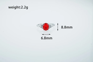 Macro detail of vintage red oval gemstone ring with side stones and dimension labels