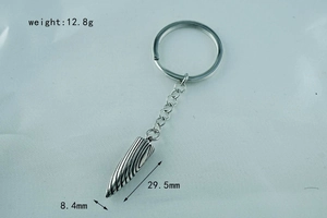 Detailed view of silver bullet-shaped keychain with 29.5mm x 8.4mm dimensions and 12.8g weight