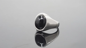Macro shot of silver polished steel ring featuring an oval black agate stone inlay