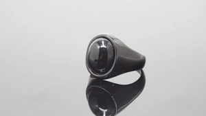 Detailed macro view of men's vintage black gemstone ring with polished metal frame