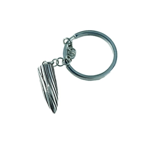 Men's titanium steel bullet keychain with vintage spiral texture on white background