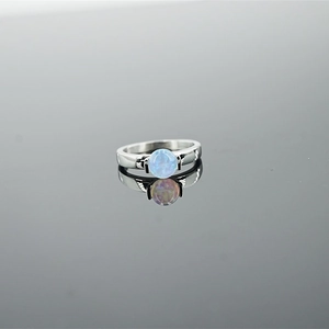 Minimalist silver steel ring featuring a round light blue opal stone on a reflective base