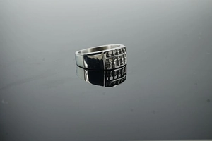 Detailed macro shot of vintage abacus pattern on polished silver stainless steel ring