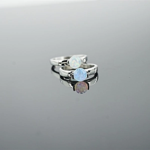 Minimalist silver rings set with blue and white opal stones in a four-prong setting