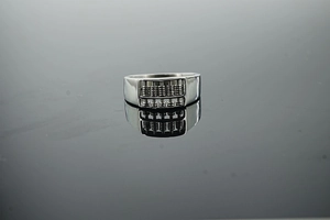 Detailed close-up of a movable abacus ring with vintage stainless steel finish and mirror reflection