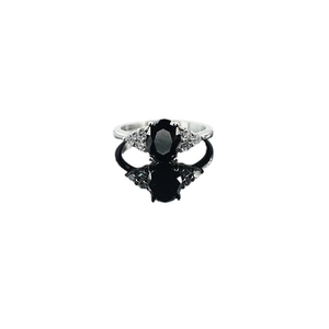Elegant three-stone silver ring with large oval black gemstone and sparkling accents