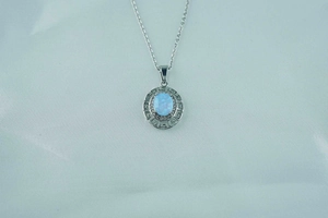 Detail of opal necklace featuring a silver Greek meander frame with tiny zircons