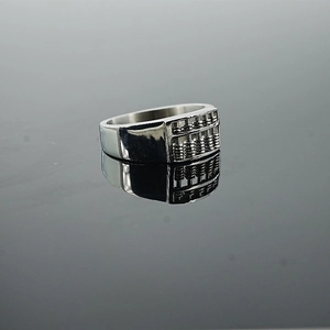 Vintage stainless steel abacus ring with movable beads on black reflective background