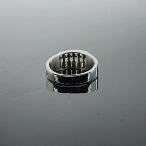 Retro stainless steel abacus ring with rotatable beads on a dark reflective background