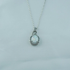 Elegant titanium steel necklace featuring a teardrop opal pendant with diamond accents
