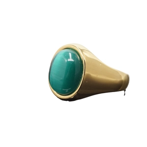 Golden stainless steel ring with an oval green cat-eye gemstone in a minimalist design