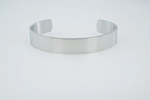 Detailed view of the smooth polished surface and adjustable open end of the silver steel bangle