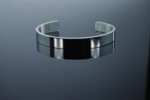 Polished silver cuff bangle featuring a mirror finish and brushed interior texture
