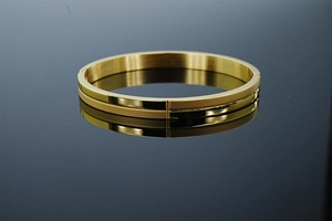 Macro shot of 8mm wide gold stainless steel hinge bracelet with matte and polished finish